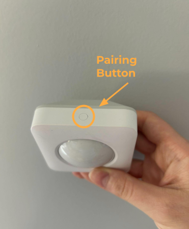 The Motion Sensor Gen 2, with a circle highlighting the pairing button found on the top of the device.