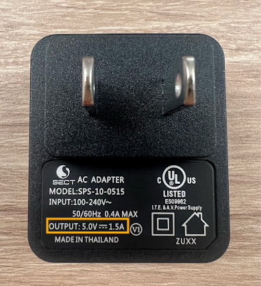 The backside of a power adapter with the output voltage highlighted to reflect that this power adapter meets our standards as outlined within this article.