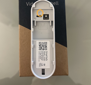 30ce1d9a-5531-4640-a0bc-b441fe098057.png The back side of the Video Doorbell Pro, with the larger button on the left circled.